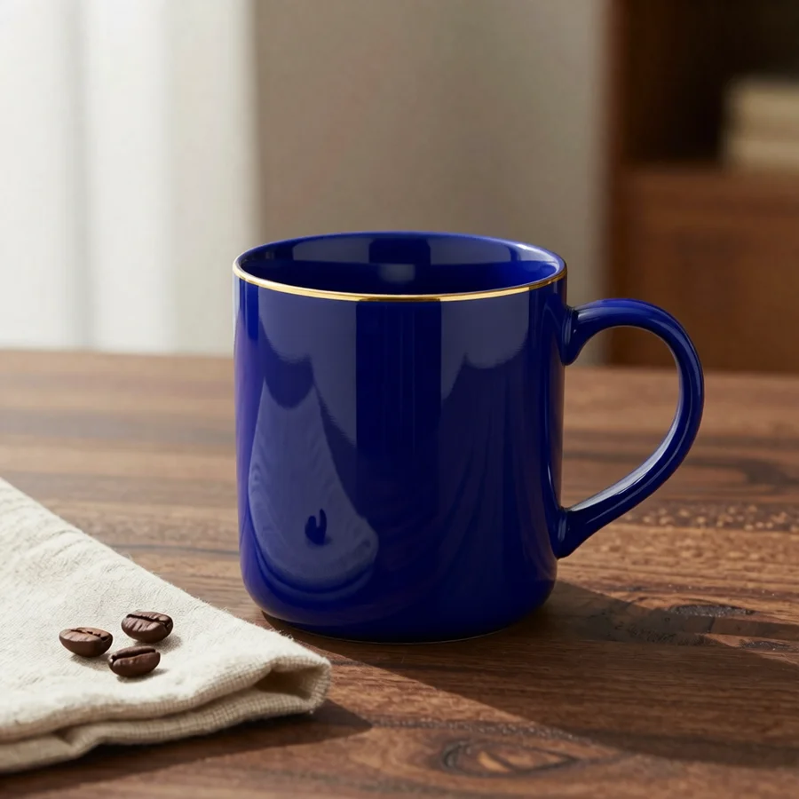 The same mug in a cobalt blue glaze with its gold rim